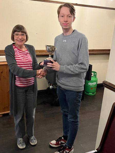 Julie presents Dan with the President's cup